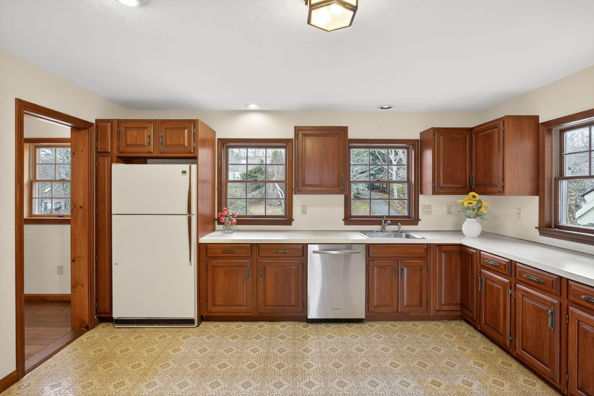 4 Earl Road East Sandwich, MA 02537 - Photo 6 of 63 a kitchen with stainless steel appliances granite countertop a refrigerator a sink dishwasher a stove with wooden cabinets and floor