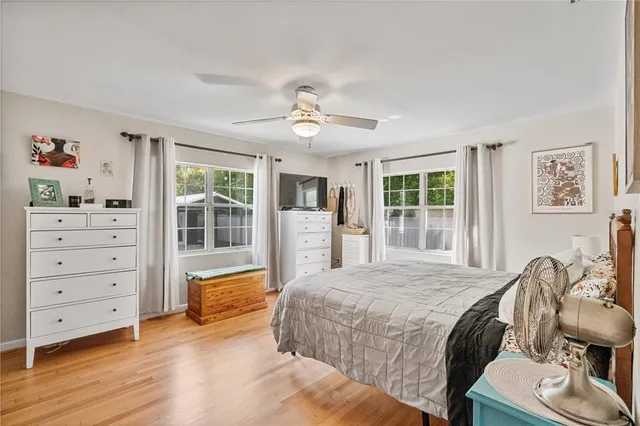 a room with lots of tables a large window and furniture