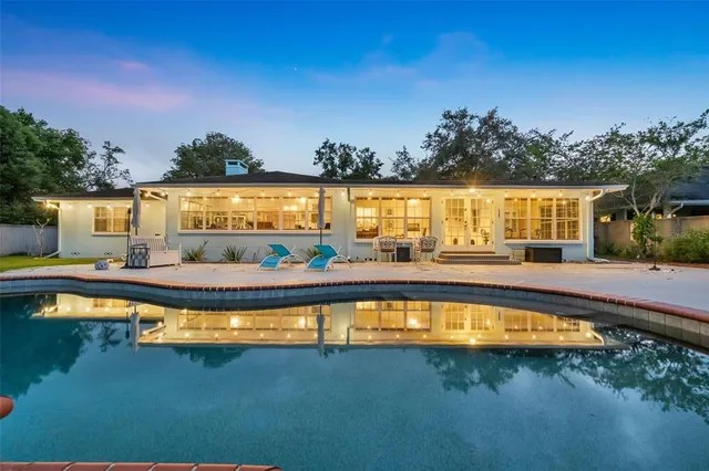 a living room with furniture and a large window with wooden floor