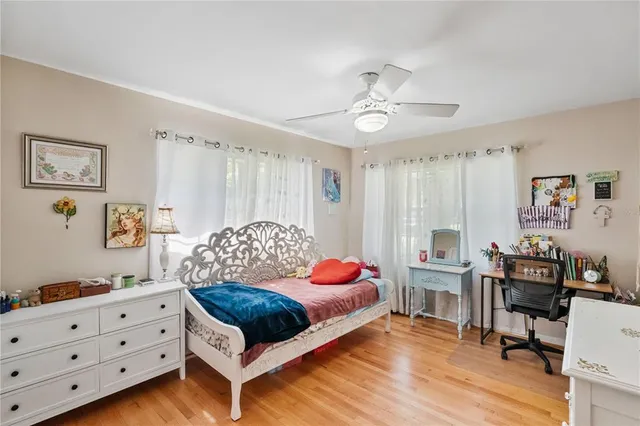 a bedroom with furniture and a large window