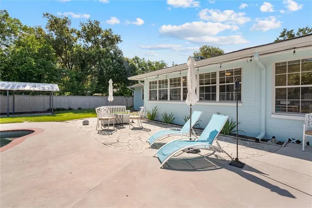 a view of swimming pool with a yard and outdoor seating