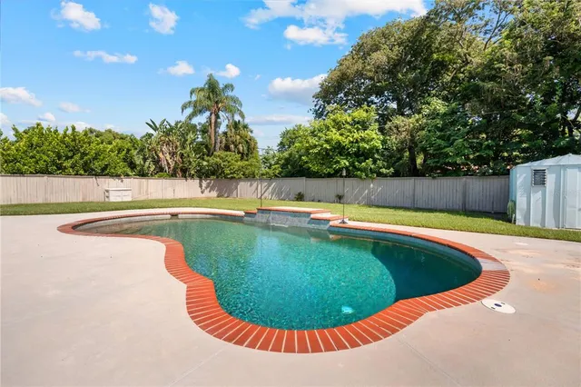 a view of a house with swimming pool and sitting area