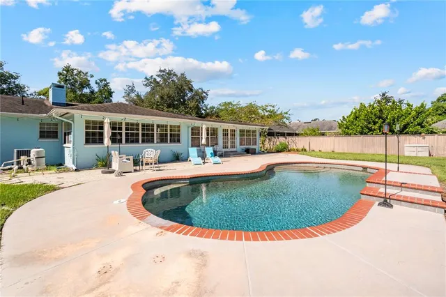 a spacious bedroom with a bed and wooden floor