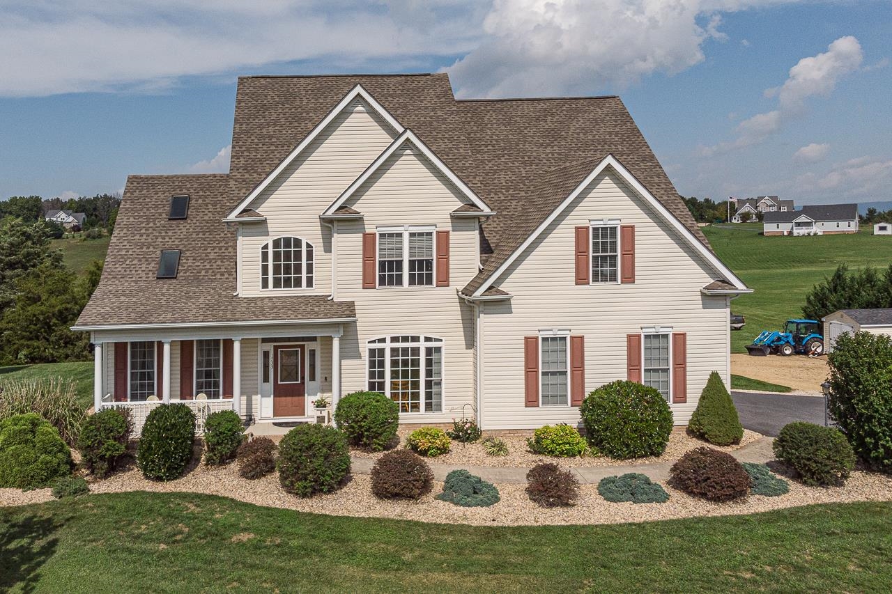 a view of a house with backyard porch and outdoor seating