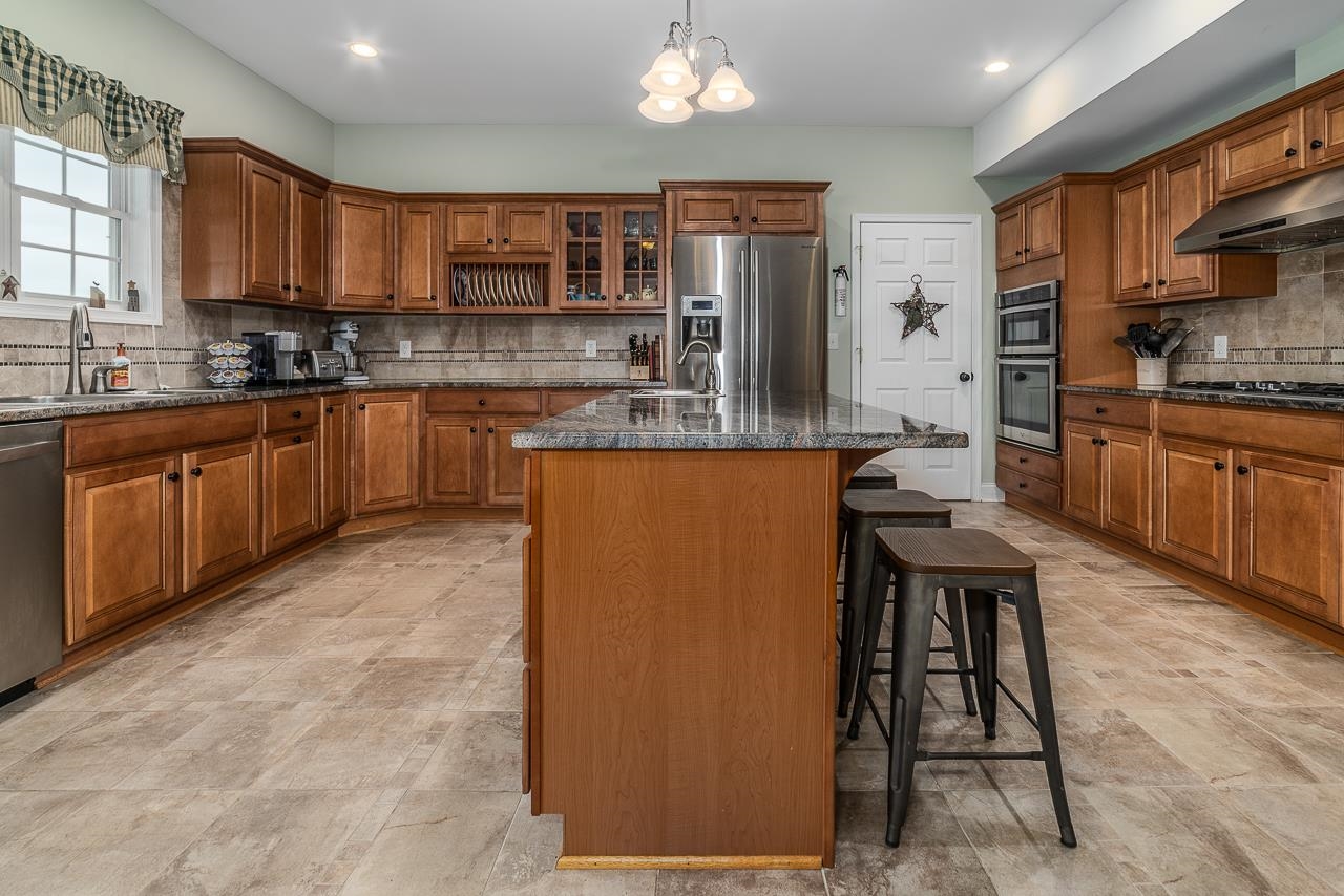 1733 Ridge Road Raphine, VA 24472 - Photo 15 of 32 a kitchen with stainless steel appliances granite countertop a refrigerator sink and cabinets
