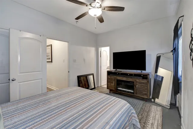 a bedroom with a bed and a flat screen tv