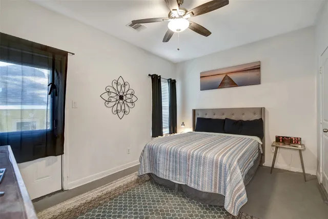 a bedroom with a bed and a window