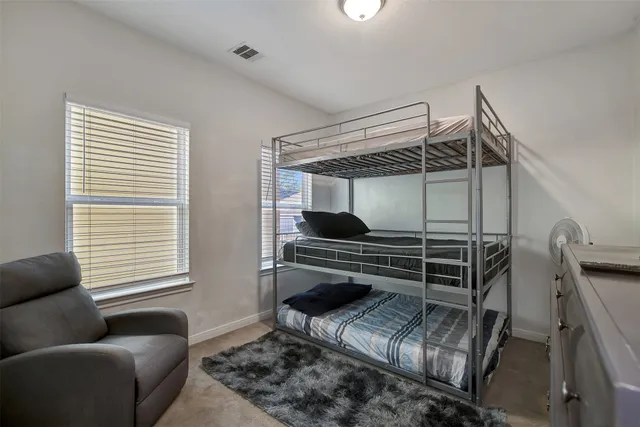 a bedroom with furniture and a window