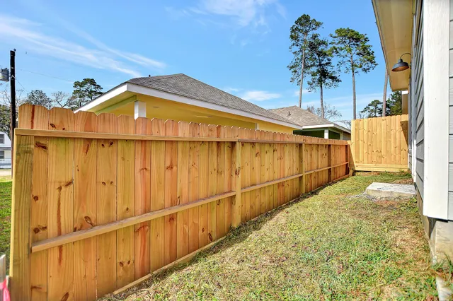 a backyard of a house with wooden fence