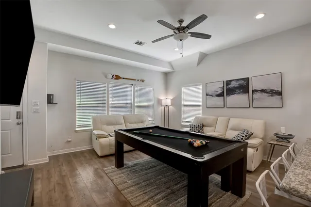 a living room with a table chairs and a window