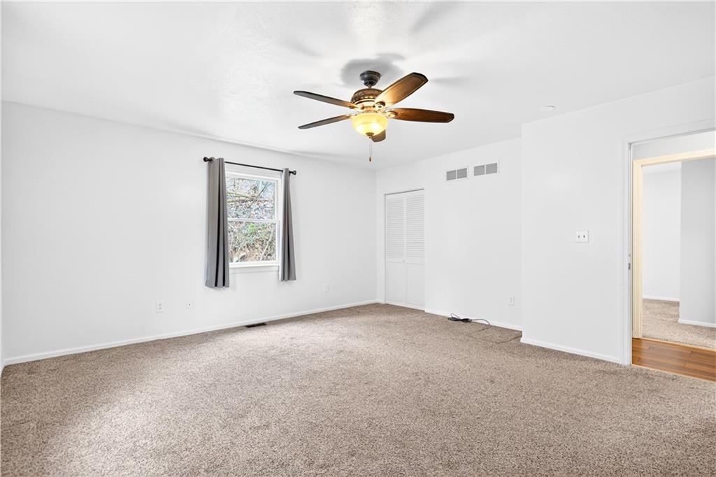 1270 Mudlick Hollow Road Beaver, PA 15009 - Photo 21 of 49 Plush carpet and ceiling fan in the primary bedroom.