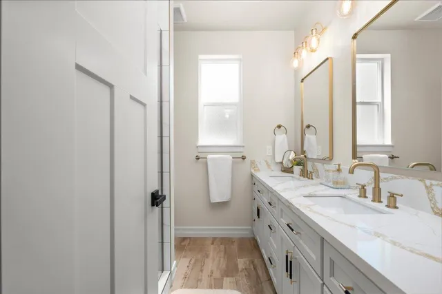 a bathroom with a double vanity sink and mirror