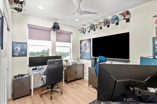 a view of a livingroom with workspace and a window