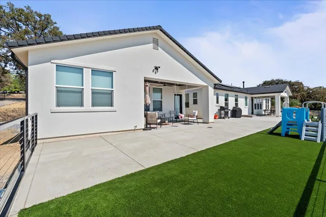 a view of house that has a yard