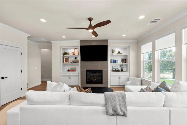 a living room with furniture a fireplace and a large window