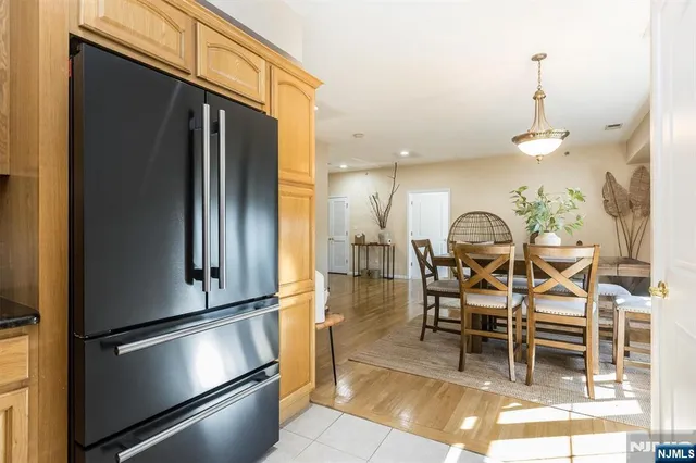 a kitchen with stainless steel appliances kitchen island granite countertop a refrigerator and a stove