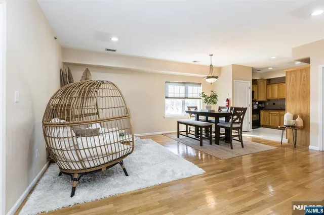 a living room with furniture a dining table a rug and a window