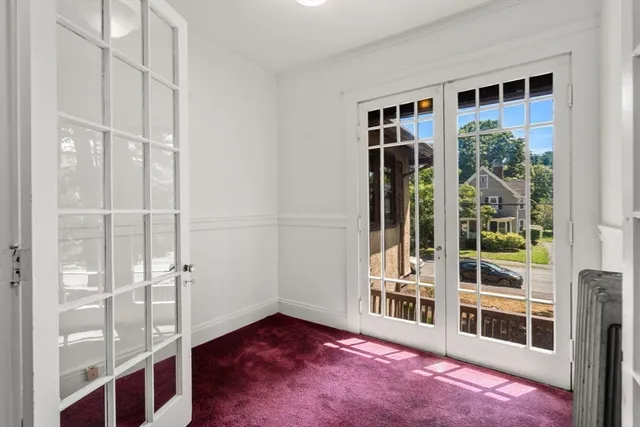a view of an entryway with wooden floor and windows