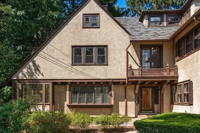 a front view of a house with a garden