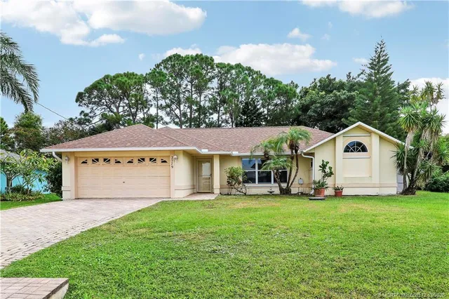 a view of house with yard and green space