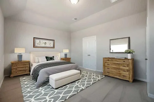 a bedroom with a bed and a dresser