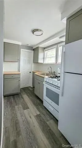 a kitchen with a cabinets and white appliances