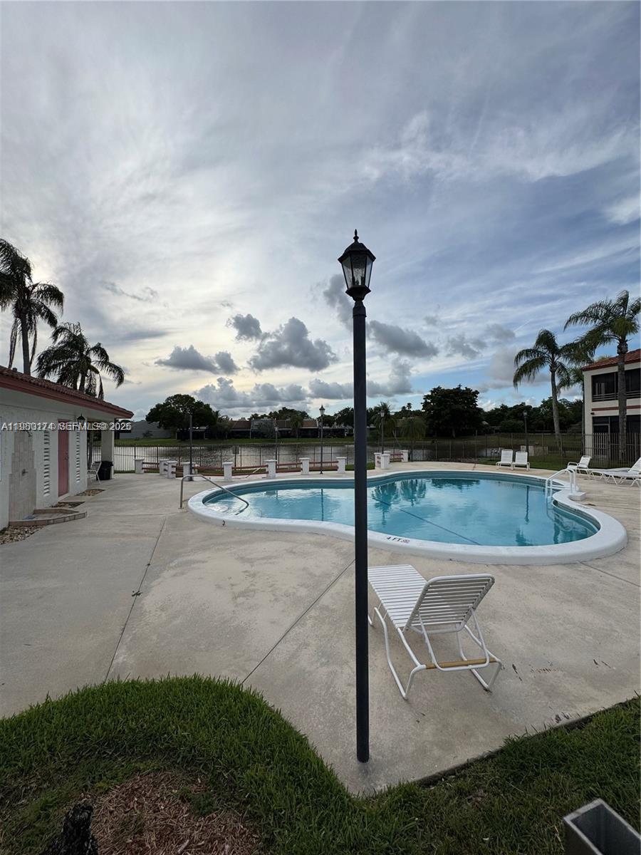 1226 North Hiatus Road, Unit 1226 Pembroke Pines, FL 33026 - Photo 3 of 10 a view of a swimming pool with a yard