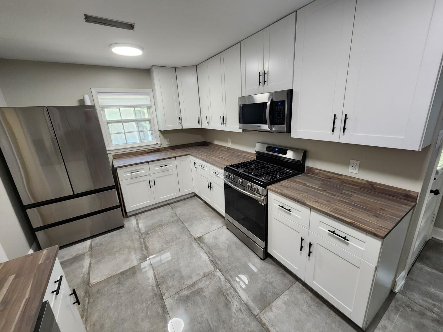 5259 Sequoia Road Memphis, TN 38120 - Photo 12 of 36 a kitchen with granite countertop white cabinets and white appliances