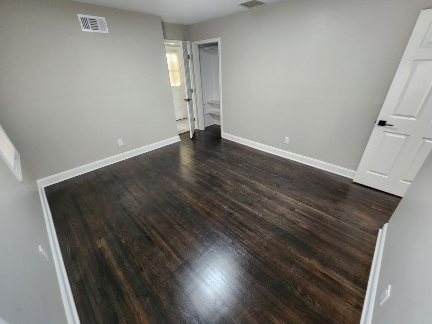 5259 Sequoia Road Memphis, TN 38120 - Photo 16 of 36 an empty room with wooden floor and windows