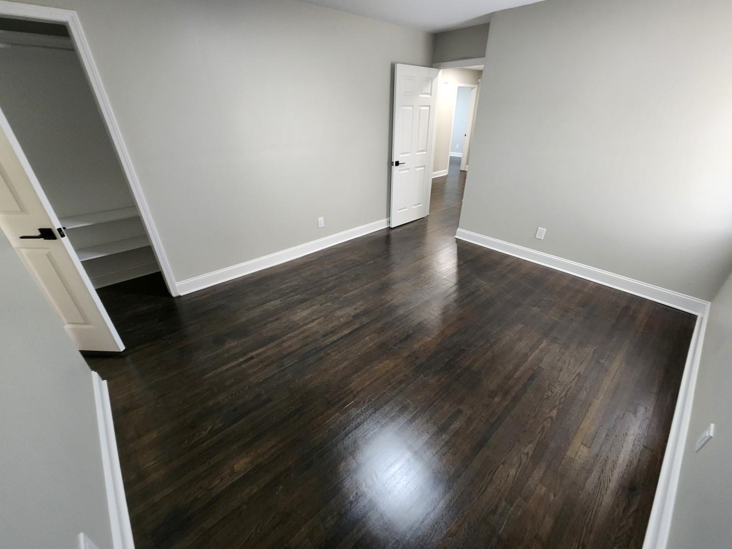 5259 Sequoia Road Memphis, TN 38120 - Photo 18 of 36 an empty room with wooden floor and windows