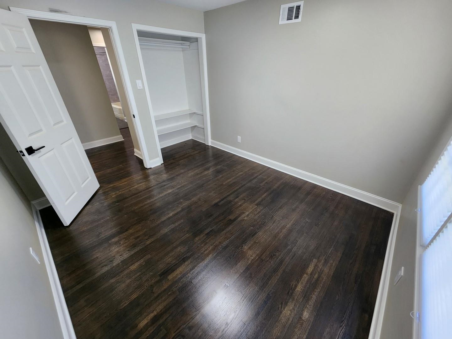 5259 Sequoia Road Memphis, TN 38120 - Photo 23 of 36 an empty room with wooden floor and entrance