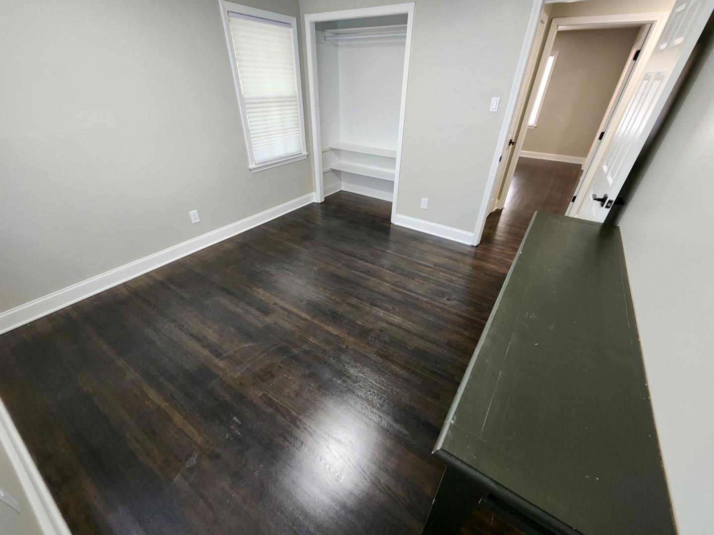 5259 Sequoia Road Memphis, TN 38120 - Photo 25 of 36 an empty room with wooden floor and windows