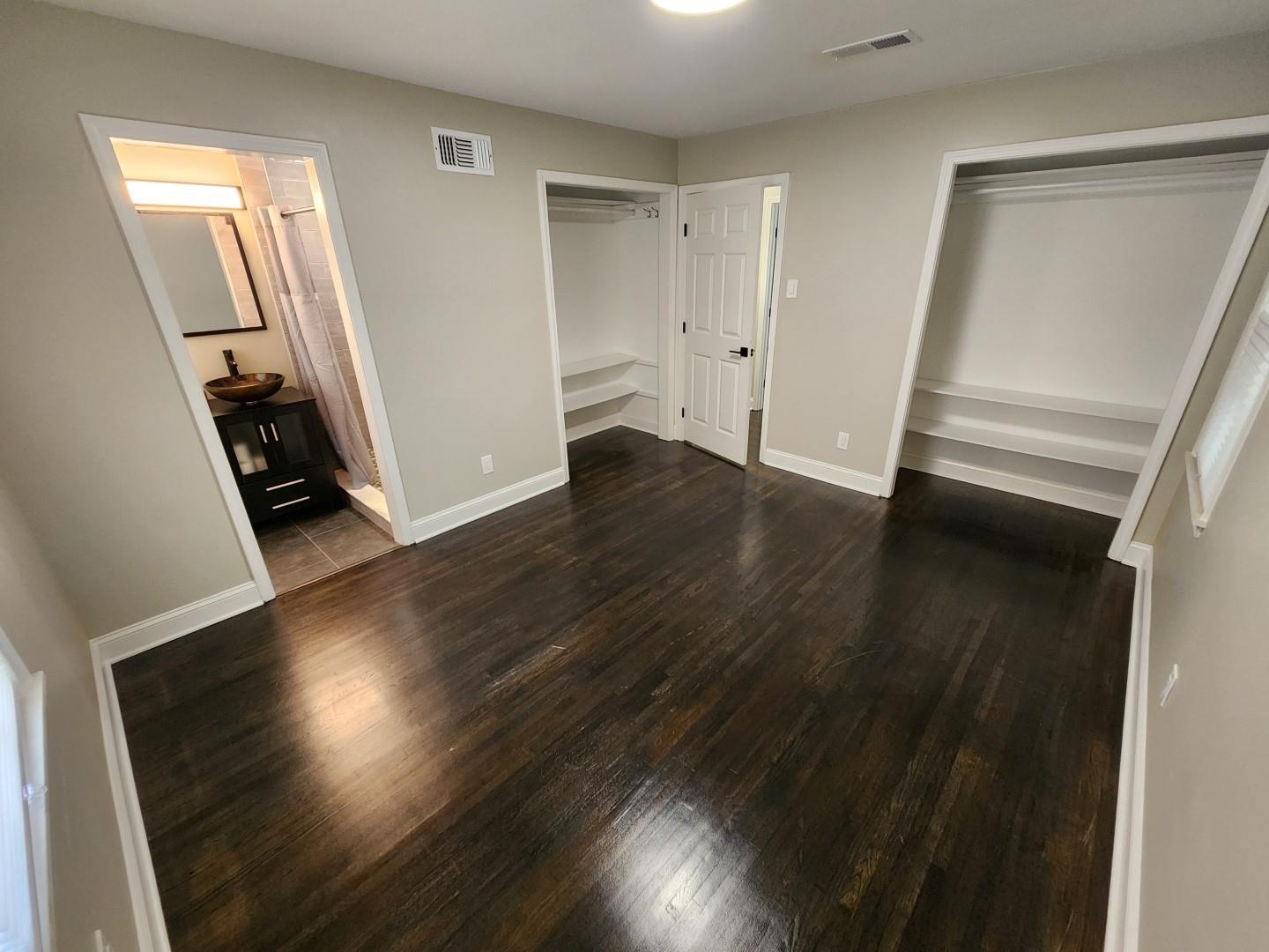 5259 Sequoia Road Memphis, TN 38120 - Photo 28 of 36 an empty room with wooden floor and entrance
