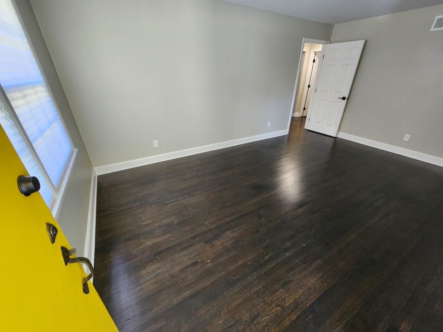 5259 Sequoia Road Memphis, TN 38120 - Photo 5 of 36 an empty room with wooden floor and windows