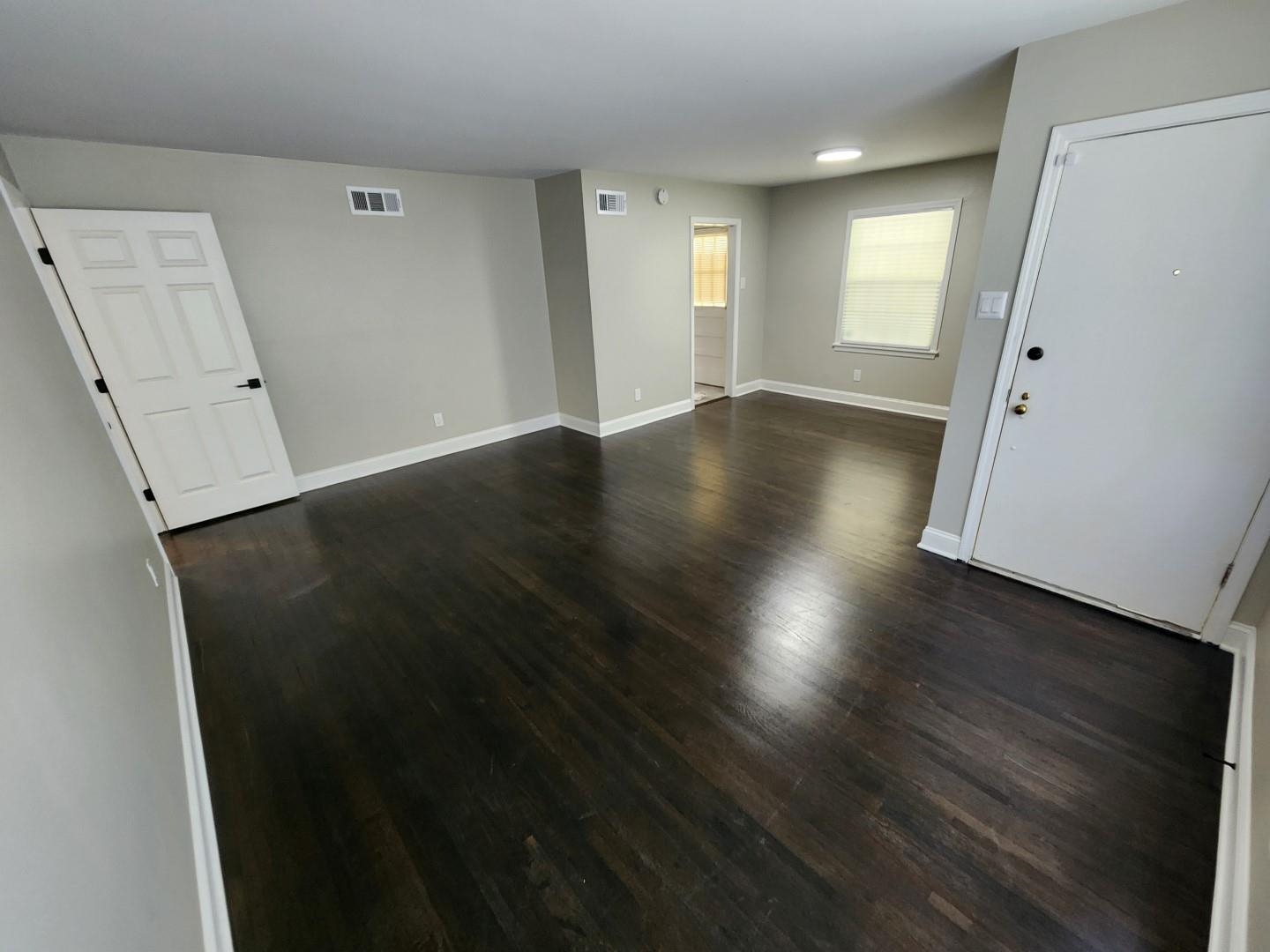 5259 Sequoia Road Memphis, TN 38120 - Photo 6 of 36 an empty room with wooden floor and windows