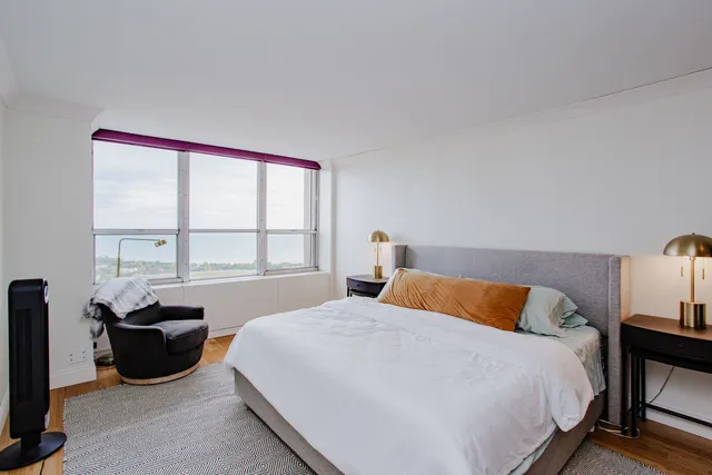 a bedroom with a bed and a bookshelf