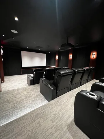 a living room with furniture a rug and kitchen view