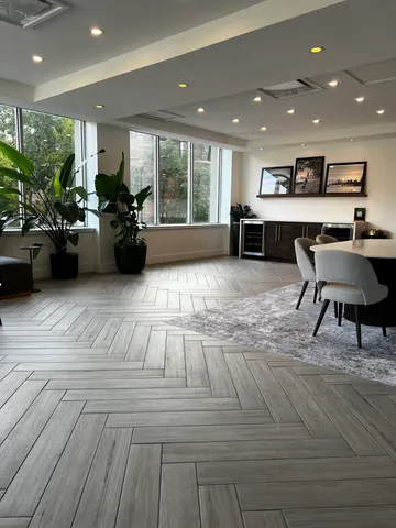 a living room with large window and furniture