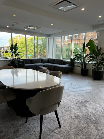 a view of a patio with dining table and chairs and potted plants