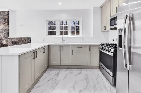 a kitchen with a stove microwave and refrigerator