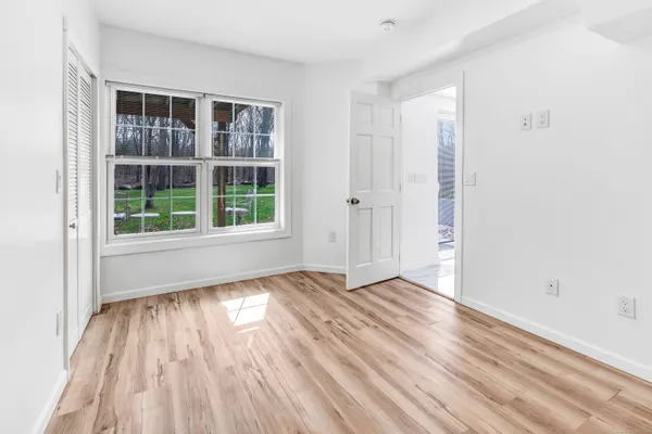 a view of a big house with a big yard and large trees