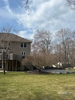 a view of a house with backyard and sitting area