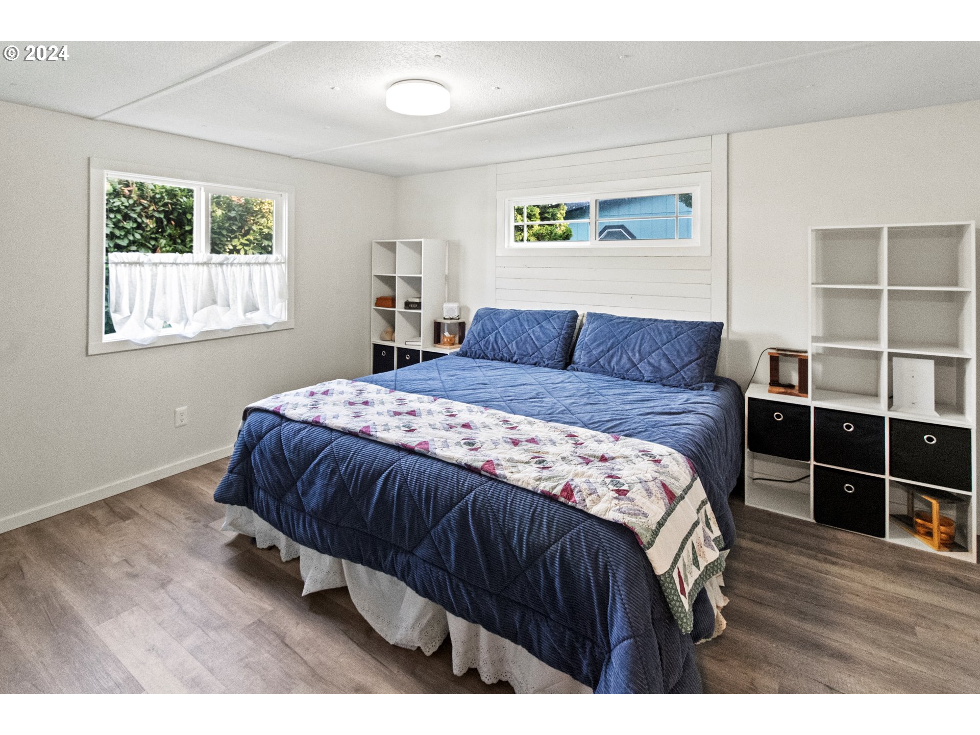 1400 Candlelight Drive, Unit 185 Eugene, OR 97402 - Photo 27 of 46 a bedroom with a bed windows and a window