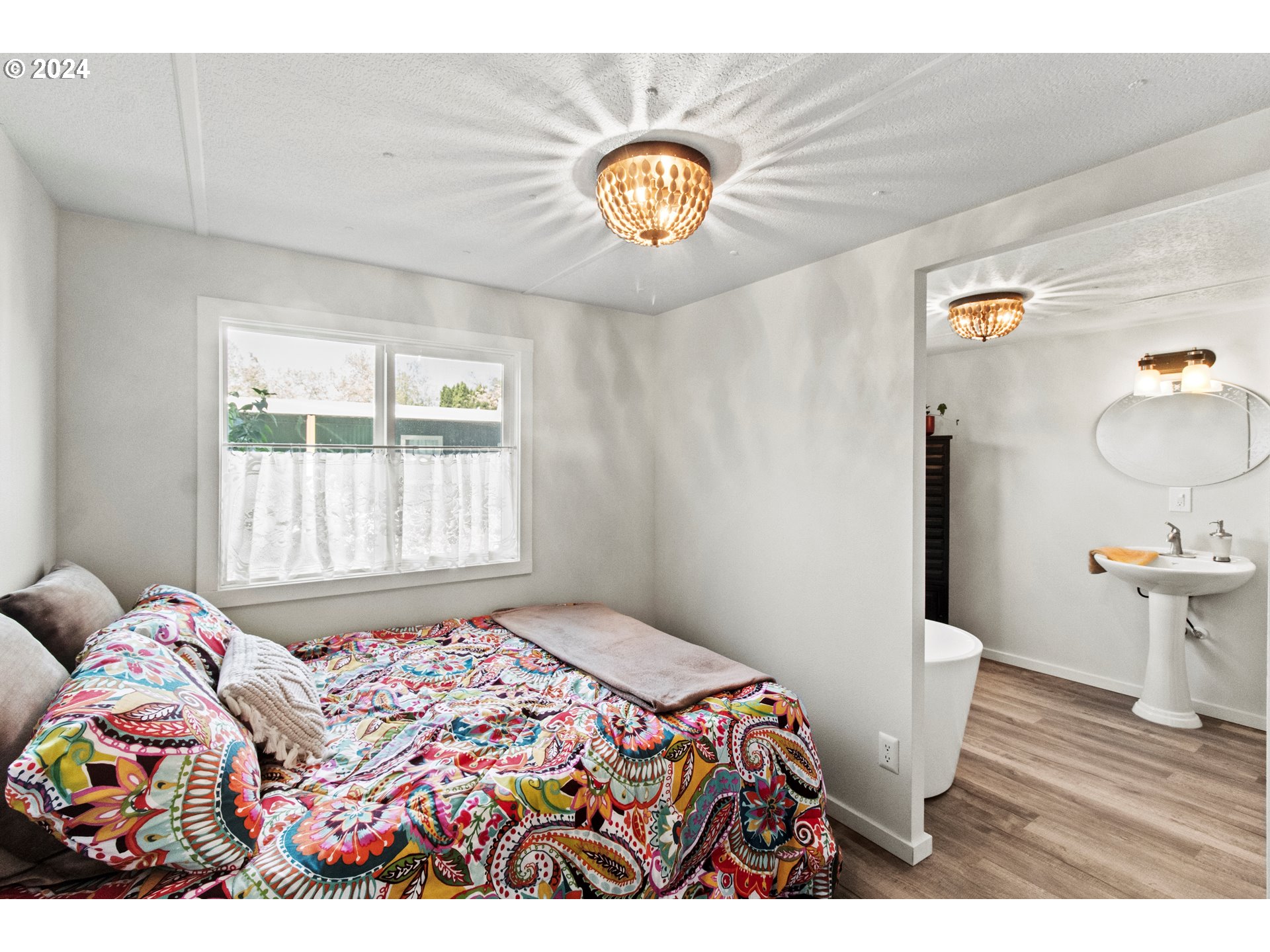 1400 Candlelight Drive, Unit 185 Eugene, OR 97402 - Photo 30 of 46 a bedroom with a bed and window