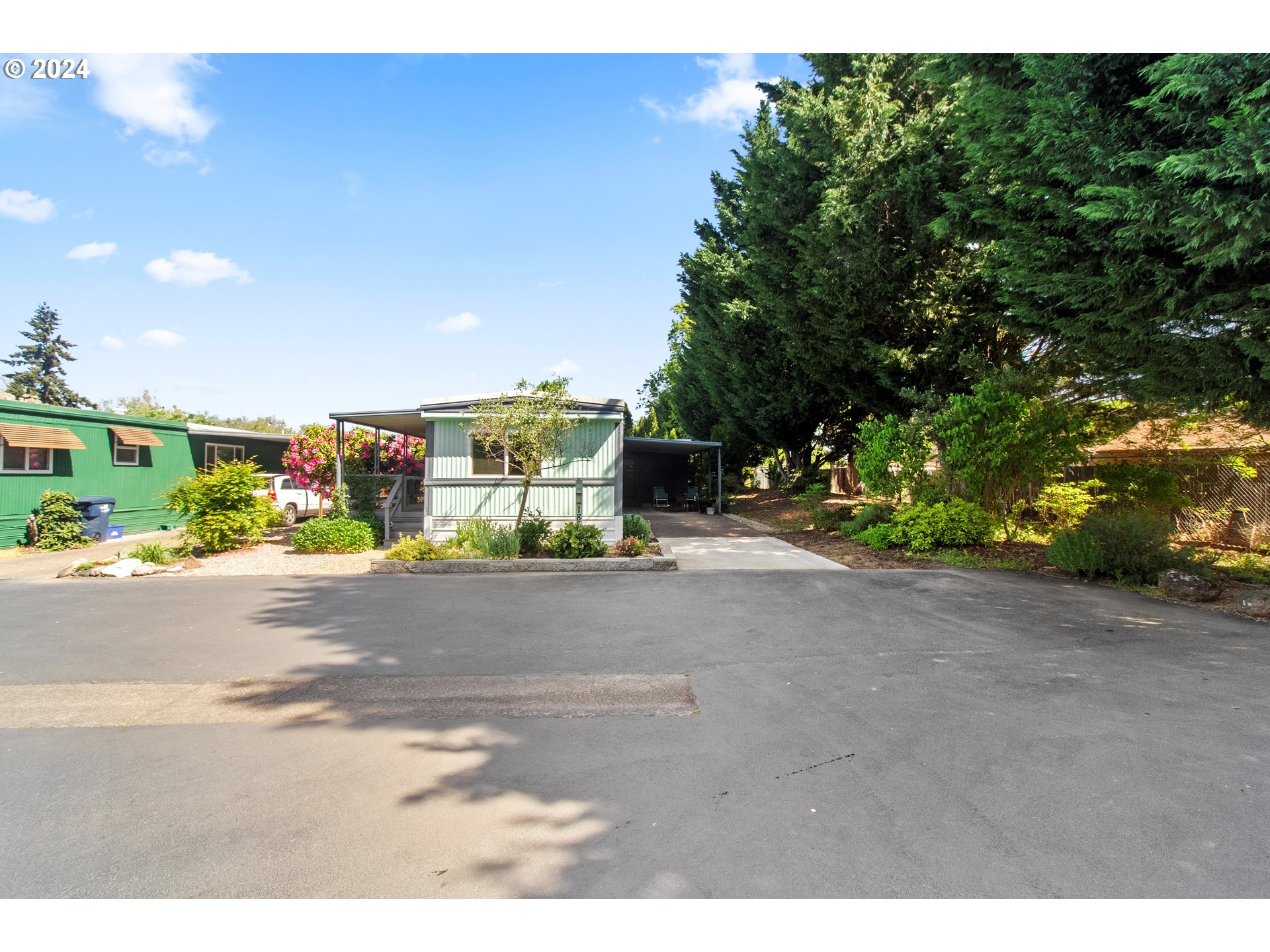 1400 Candlelight Drive, Unit 185 Eugene, OR 97402 - Photo 4 of 46 a street view with large trees