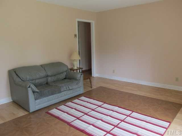 1923 Shaw Road Durham, NC 27704 - Photo 2 of 17 a living room with furniture and a rug