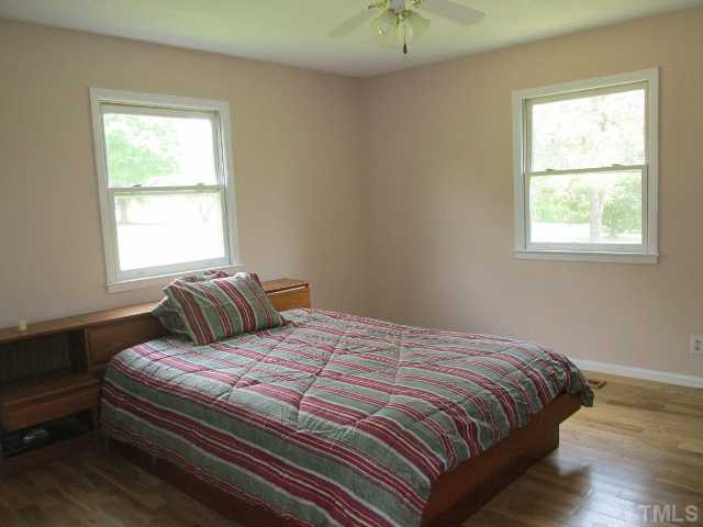 1923 Shaw Road Durham, NC 27704 - Photo 7 of 17 a bedroom with a bed and a window