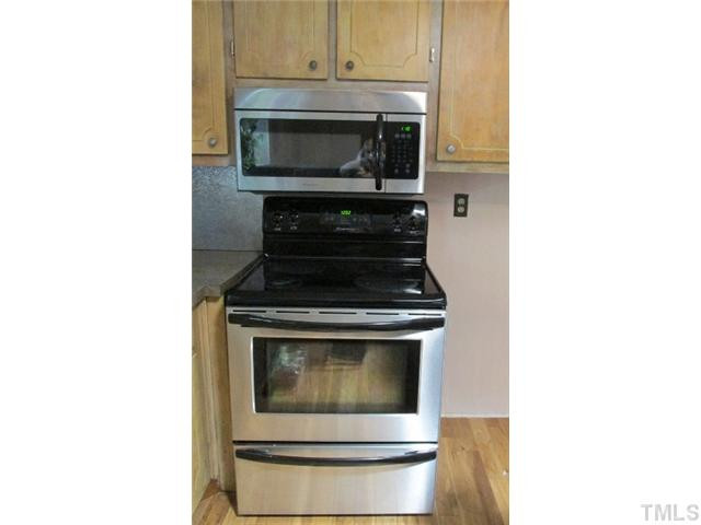 1923 Shaw Road Durham, NC 27704 - Photo 10 of 17 a kitchen with a stove and a microwave