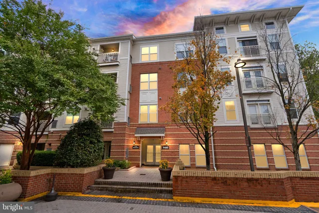 a front view of a residential apartment building with a yard