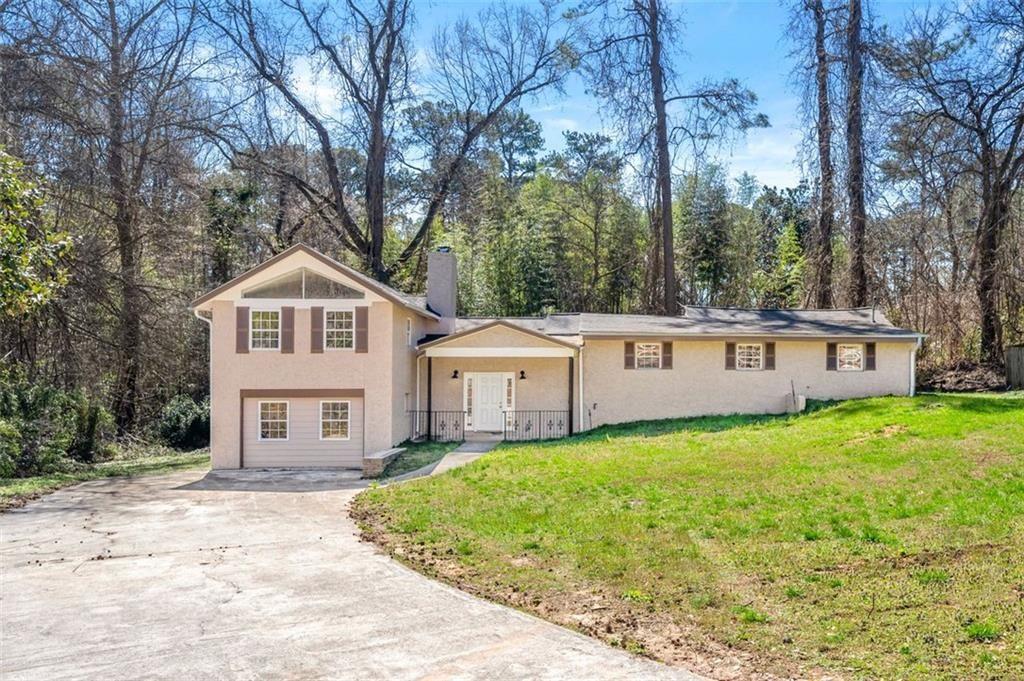 3480 Hogan Road Southwest Atlanta, GA 30331 - Photo 1 of 25 a house that has a tree in front of it